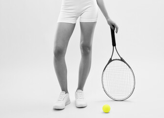 A beautiful attractive girl in white shorts and a top plays tennis. The concept of sports and healthy lifestyle.