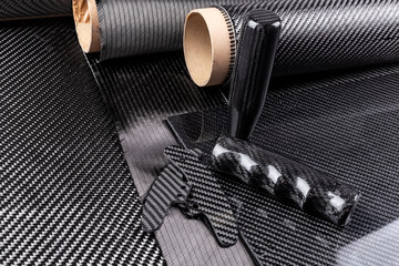 lightweight carbon fiber tuning parts and CFK sheet on composite  raw material cloth.  automotive and car racing  industry high tech background.