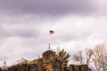 Beautiful view of the American flag flying high on a mountain near Peterson Falls in New Jersey....