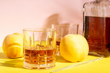 Rum or Amaretto sour with ice in a glass on a bright background. Summer party concept.