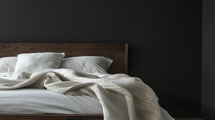 Modern bedroom furniture close-up, showcasing a contemporary bed with a white blanket, front view against a dark backdrop, isolated on white