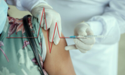 Vaccine damage concept, medical person injecting patient with flatline emerging from the needle