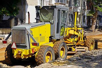 Grader on road construction site