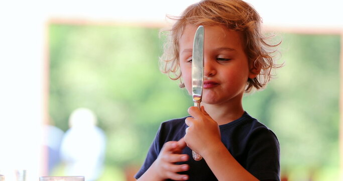 Little boy playing with knife mother removes dangerous knife from hand