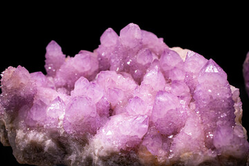Purple crystals on black background. Amethyst quartz cactus wallpaper. Polished raw gemstone...