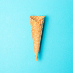 Ice cream cone on blue background. Minimal summer concept.