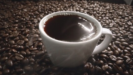 Top view of coffee or espresso with piles of coffee beans. Close up of fresh roasted coffee bean...
