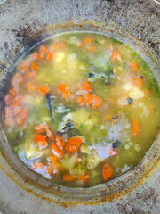 Fish soup in a cauldron. Russian ukha soup, made from various types of fish.
