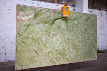 Picture of a marble slab on a hanger, shot in natural light, a cut of decorative marble in a...