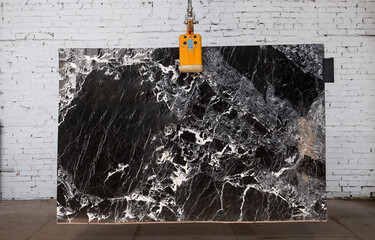 Picture of a marble slab on a hanger, shot in natural light, a cut of decorative marble in a...