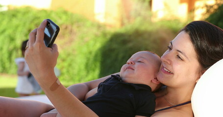 Mother taking selfie with her baby infant son