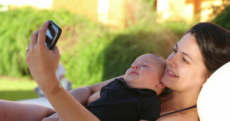 Mother taking selfie with her baby infant son