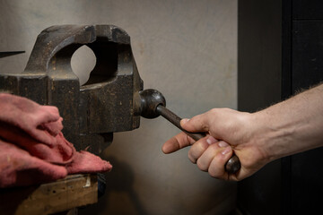Hand operated heavy duty cast iron bench vise.