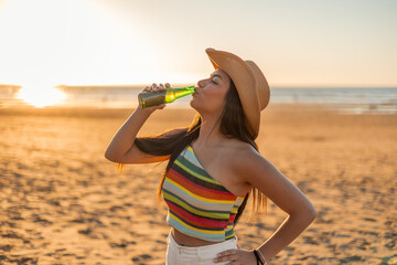 Young Multicultural Latin girl Enjoying Beer on Beach at Sunset