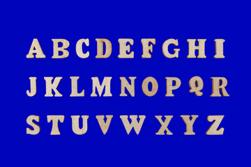 wooden letters of the English alphabet on a blue background