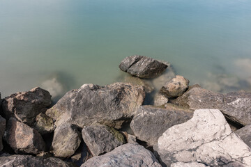 Top view of the sea rocks of Grado, Italy with long exposure, sunny day.