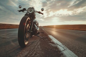 A motorcycle parked on the side of a road. Suitable for transportation concepts