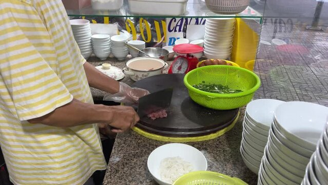 Close up of couple eating pho soup in the city. Street food soup pho
