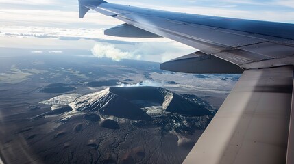 Obraz premium Scenic flight over a volcano, close-up of airplane wing with crater in background