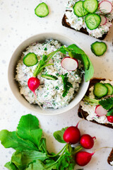 Canapes with cottage cheese with herbs and radishes.selective focus