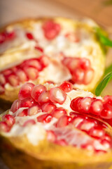 Pomegranate, a beautiful pomegranate on rustic wood, selective focus.