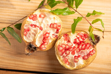 Pomegranate, a beautiful pomegranate on rustic wood, selective focus.