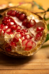 Pomegranate, a beautiful pomegranate on rustic wood, selective focus.