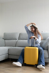 Woman posing happy ready to travel with suitcase