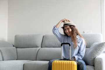 Woman posing happy ready to travel with suitcase