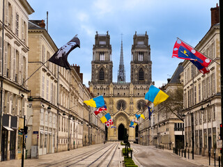 Street Joan of Arc with flags leading to majestic Gothic church