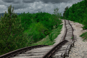 Fototapeta premium Pijana pruga or drunk railway in Istria, Croatia. A stretch of neglected railway track and bed, deformed rails, washed down by land slide or poor earth base