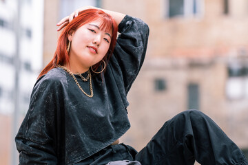 Korean fashionista poses with confidence against a casual urban background