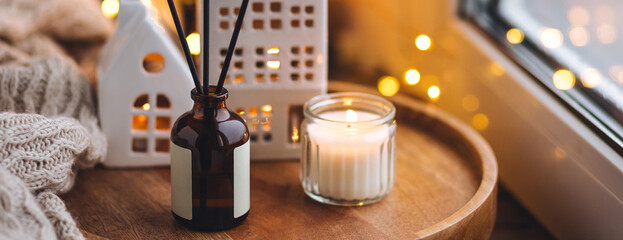 Banner. Christmas home aromatherapy. Cozy atmosphere, holiday spirit. Winter inspiration. Aroma diffuser with pine extract, organic essential oil, vanilla, gingerbread cookies, candles on wooden table