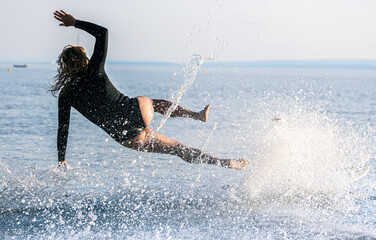 woman jumping in water