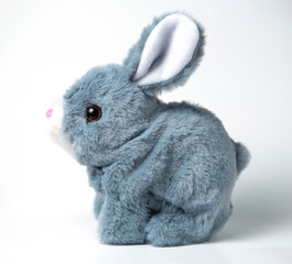 A white plush bunny on a grey background