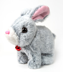 A white plush bunny on a grey background