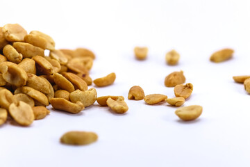 roasted salted peanuts photographed close-up on a white background