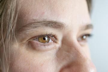 intense hazel eyes close-up, girl 25-30 years old, human eye looking to side, vision examination, myopia, eye fatigue, color perception