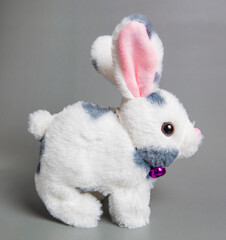 Soft fluffy rabbit toy with long ears, isolated on a white background