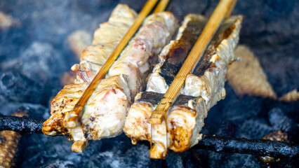 Baking and grilling marinated fish on a barbecue grill (grilled fish). Fish grilled over charcoal