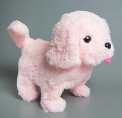 A stuffed dog toy. Cute toy puppy shot on a gray background