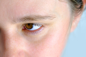 close up part of the woman's face, girl 20-29 years old, human eye looking to the side, the concept...