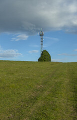 radio tower on the hill photographed during the day