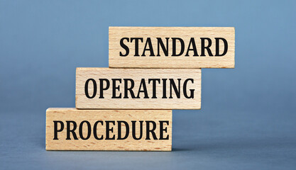 STANDARD OPERATING PROCEDURE - words on wooden blocks on blue background
