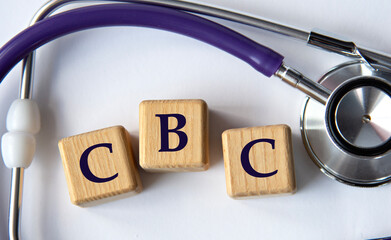 Cubes with the abbreviation CBC on the background of a stethoscope.