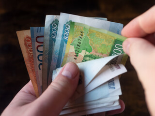Counting a Variety of Russian Banknotes in Hand