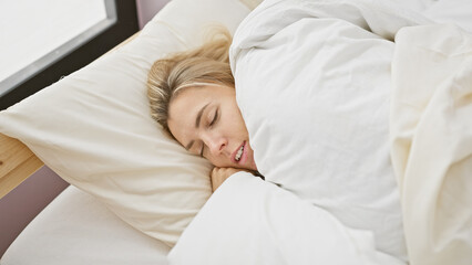 A tranquil young woman sleeps soundly in an indoor bedroom, evoking a peaceful and comfortable atmosphere.