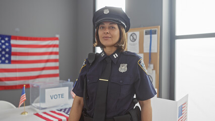 A mature woman officer stands in an american voting center, adorned with flags