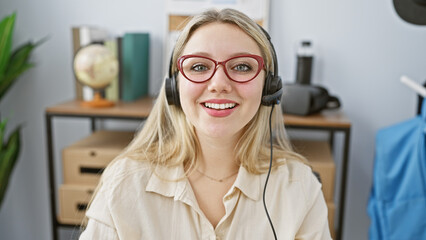Blonde woman wearing headset in modern office with glasses, smiling, professional, support, casual