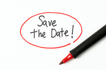 Hand writing text save the date with red marker pen - Powered by Adobe